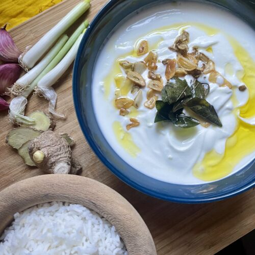 Close-up of a bowl filled with South Indian Yoghurt Curry, featuring a rich blend of three ingredients and aromatic curry leaves, creating a delicious and simple dish.