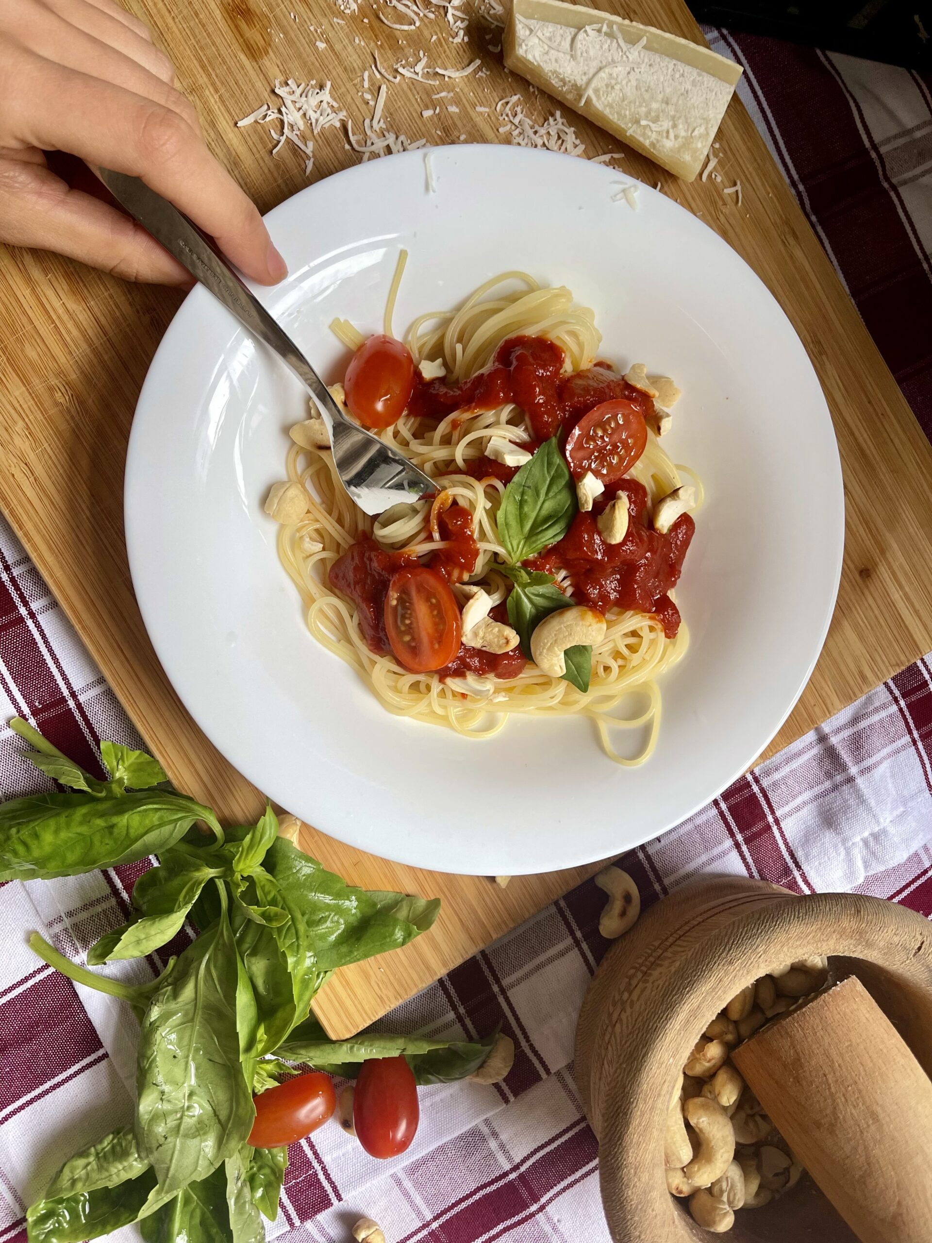 A finished plate of the 3-Ingredient Frugal Vegan Pasta, garnished with fresh basil leaves and crunchy cashews. A perfect blend of simplicity and flavor, ready to satisfy your craving for a comforting and delicious meal.