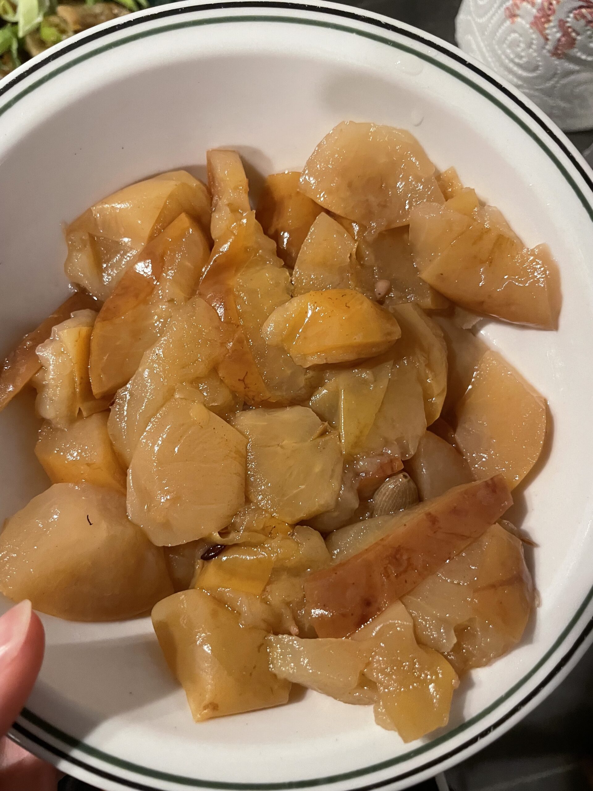 Preparing apples for Sweet Walnut & Old Apple Bread. Quartered old apples simmer in a pot with water until soft and mushy. Achieve applesauce consistency for a delightful baking experience. For a quicker option, use a pressure cooker for 10-15 minutes.