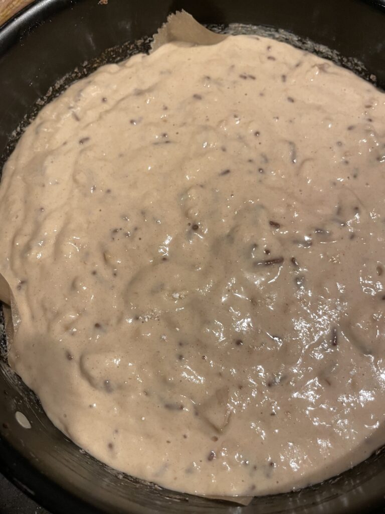 Culmination of Creation. Pouring the luscious batter, enriched with cooked apples, spices, and delightful textures, into the awaiting baking tray. The final act before the transformation of Sweet Walnut & Old Apple Bread begins in the oven.