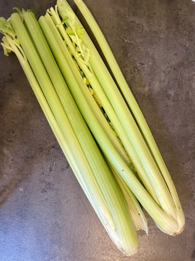 Knife at the Ready: Slicing Fresh Celery Diagonally for the Asian Culinary Adventure