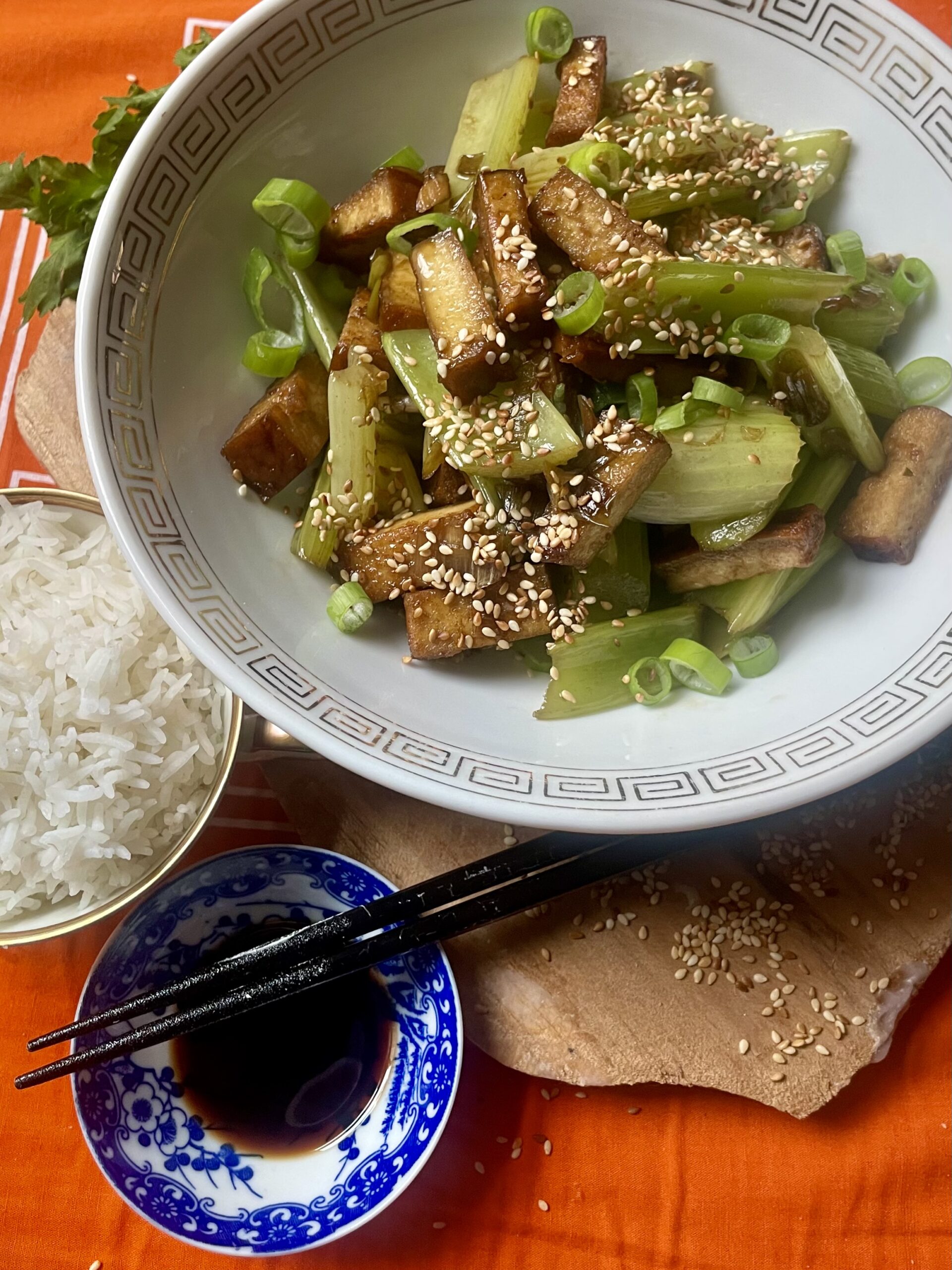 Close-up of a tantalizing vegan Asian celery dish, Beijing style, showcasing crispy tofu, vibrant spring onions, and flavorful spices.