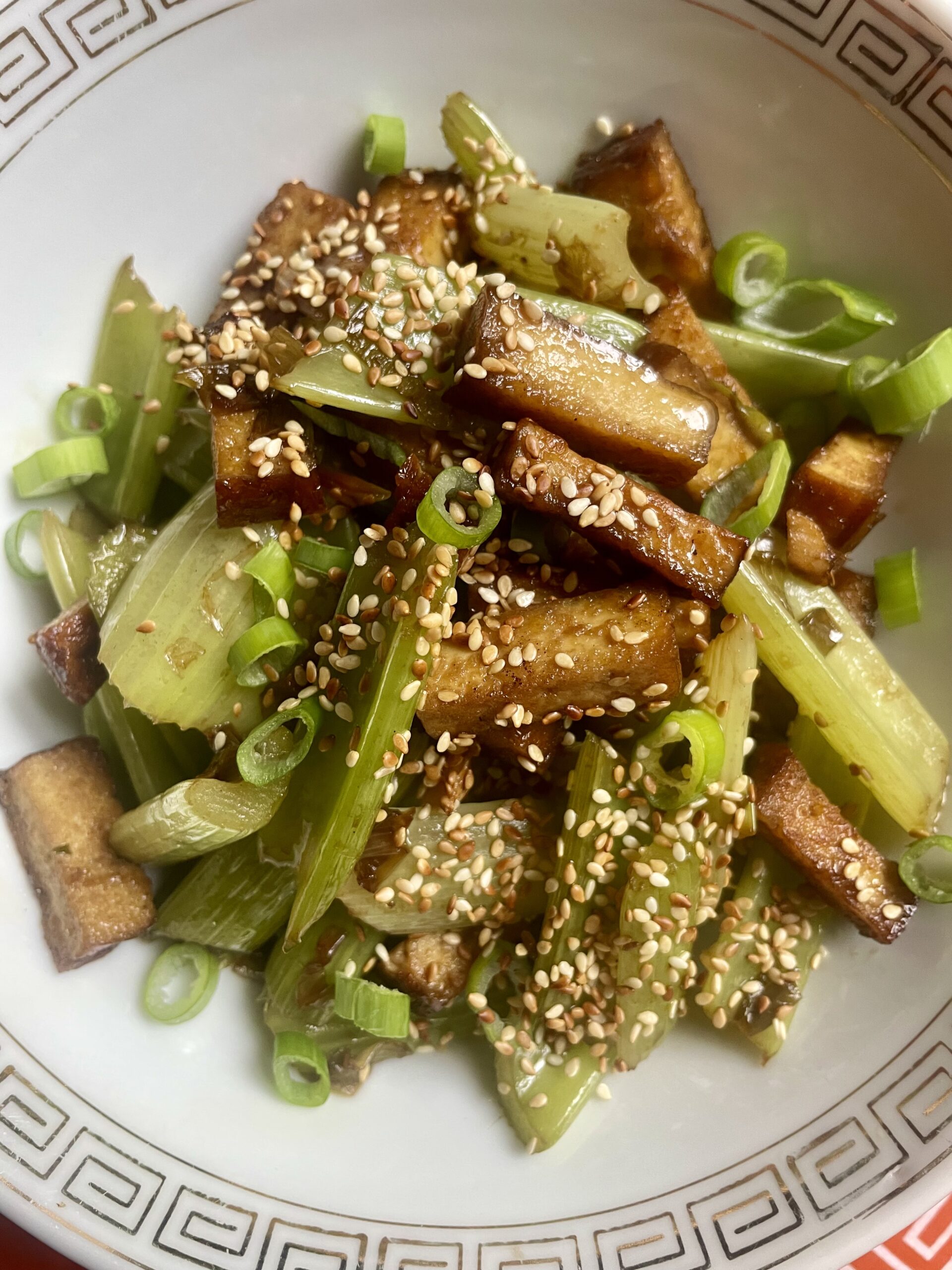 Close-up of Vegan Asian Celery Beijing Style: A Flavorful Combination of Crispy Tofu, Charred Celery, and Fragrant Sauce