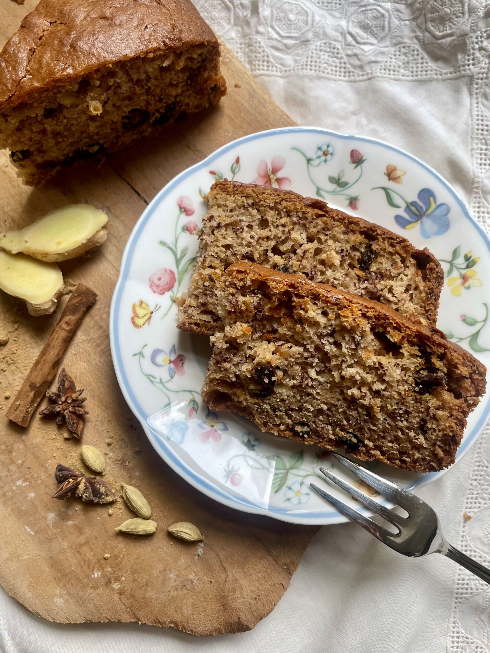 Sliced vegan cardamom sourdough banana bread on a plate, showcasing a delightful blend of flavors. Moist, aromatic, and plant-based, a perfect treat for any time of day.