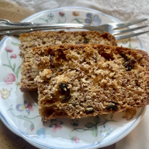 Close-up view of vegan cardamom sourdough banana bread, highlighting its moist texture, golden crust, and aromatic spices.