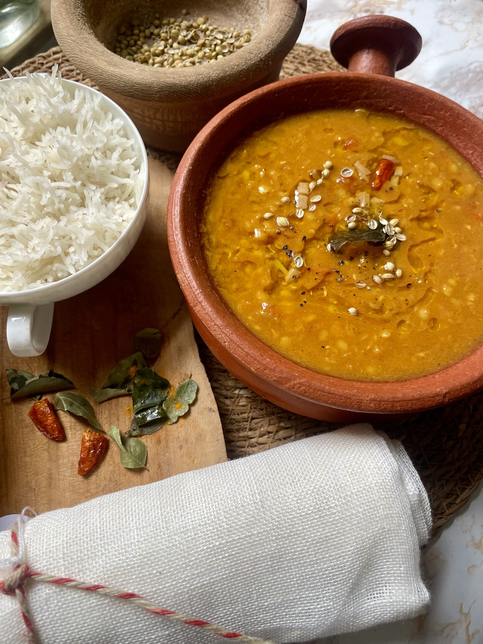 Close-up of a steaming bowl of Everyday Spiced Dal (Pressure Cooker), showcasing its vibrant colors, rich aroma, and hearty texture.