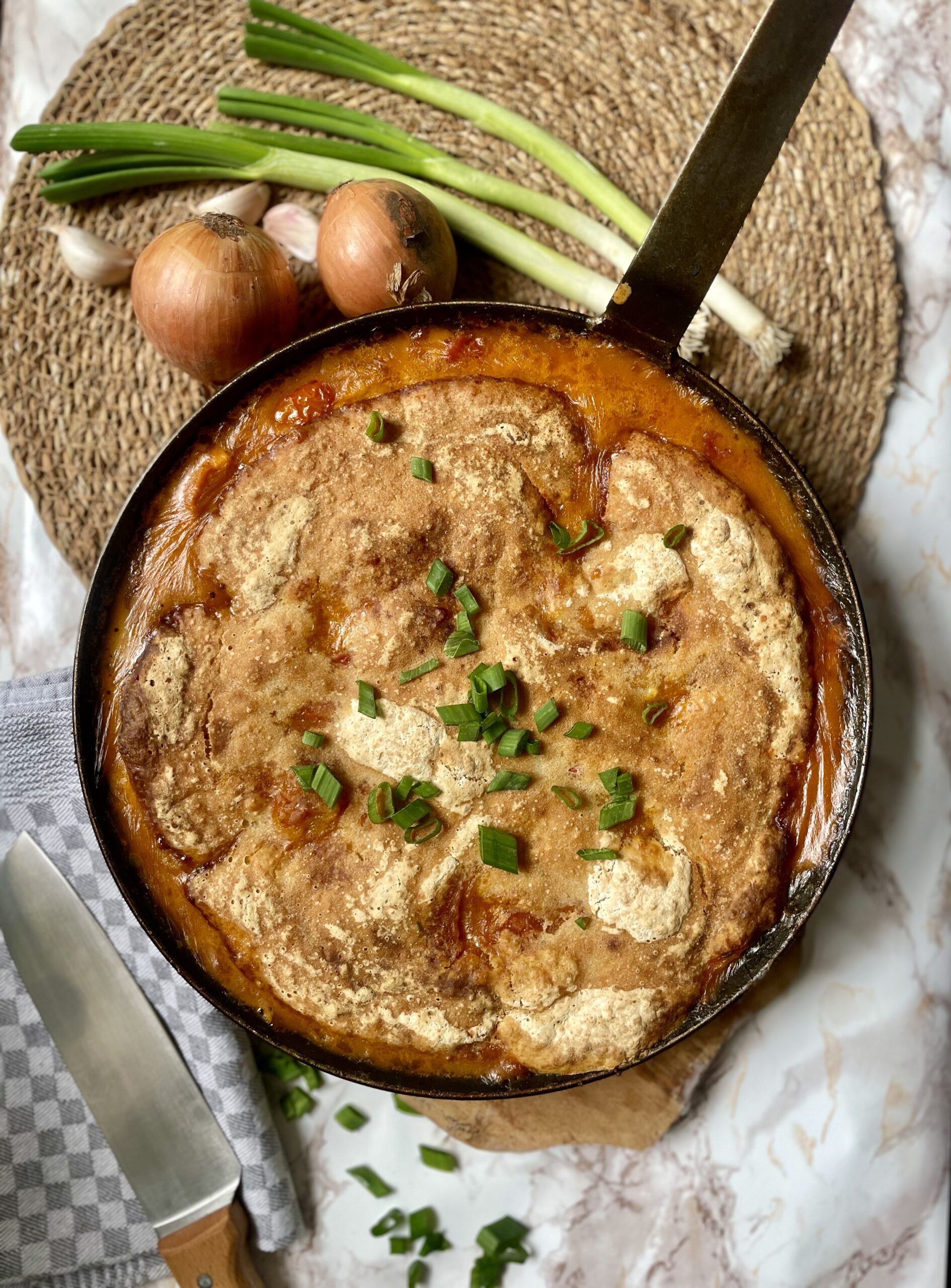 Vibrant and appetizing Spiced Dal Sourdough Skillet in a cast iron pan, showcasing a one-pot vegetarian meal with leftover dal and sourdough discard, perfect for sustainable cooking and easy tray bake meals.